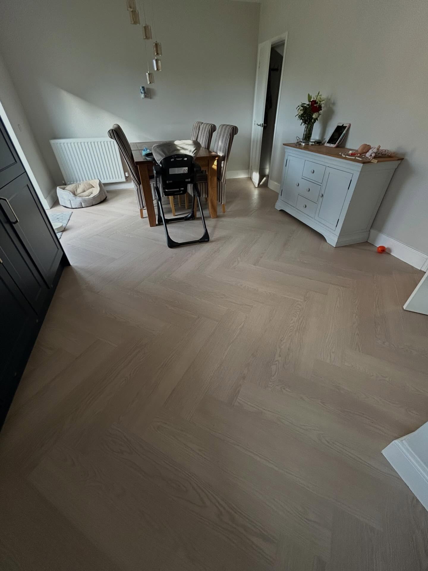 Expert herringbone flooring maintaining pattern continuity