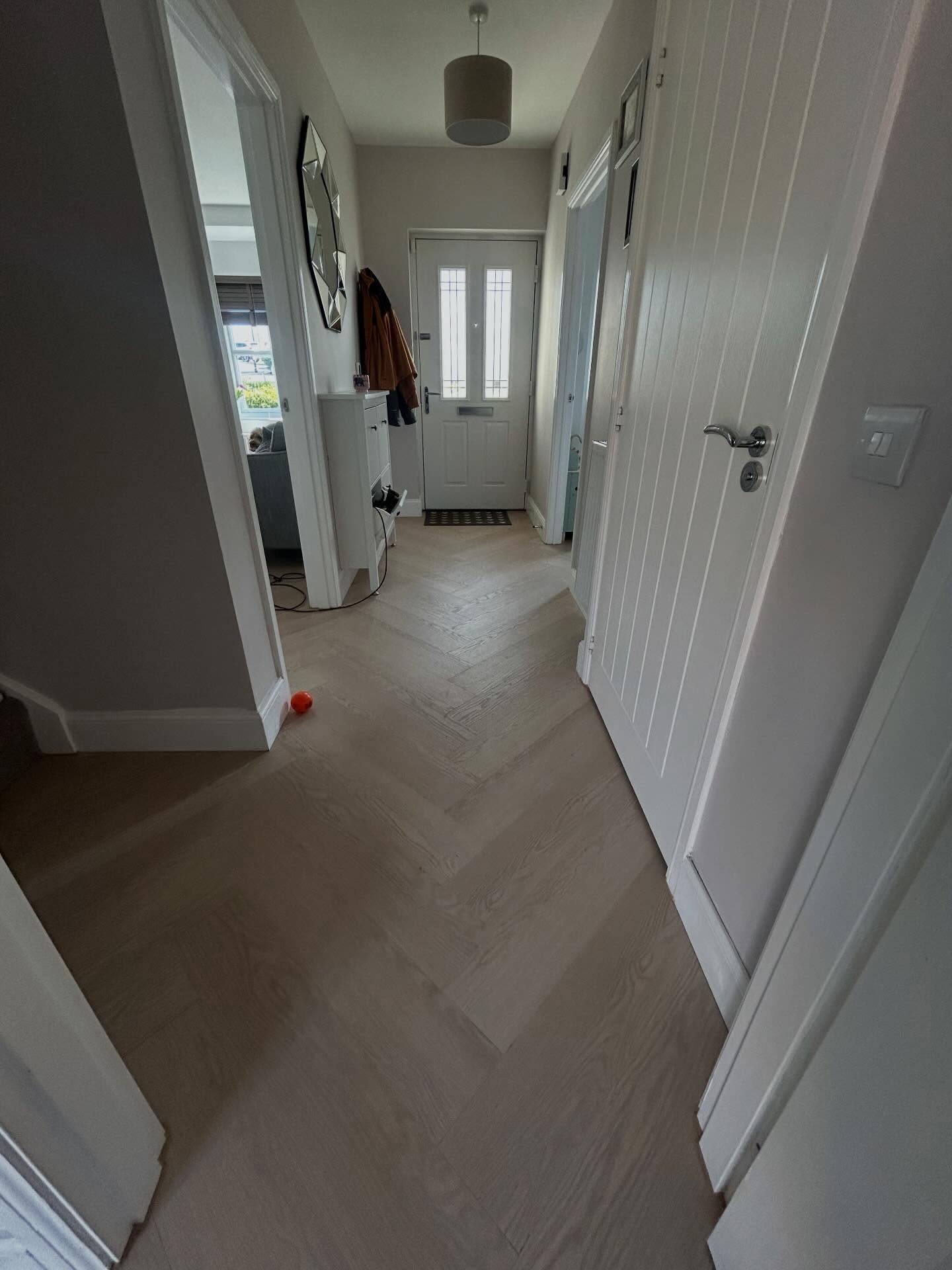 Professional continuous herringbone floor across rooms
